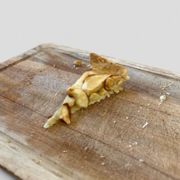 Slice of apple pie on wood board